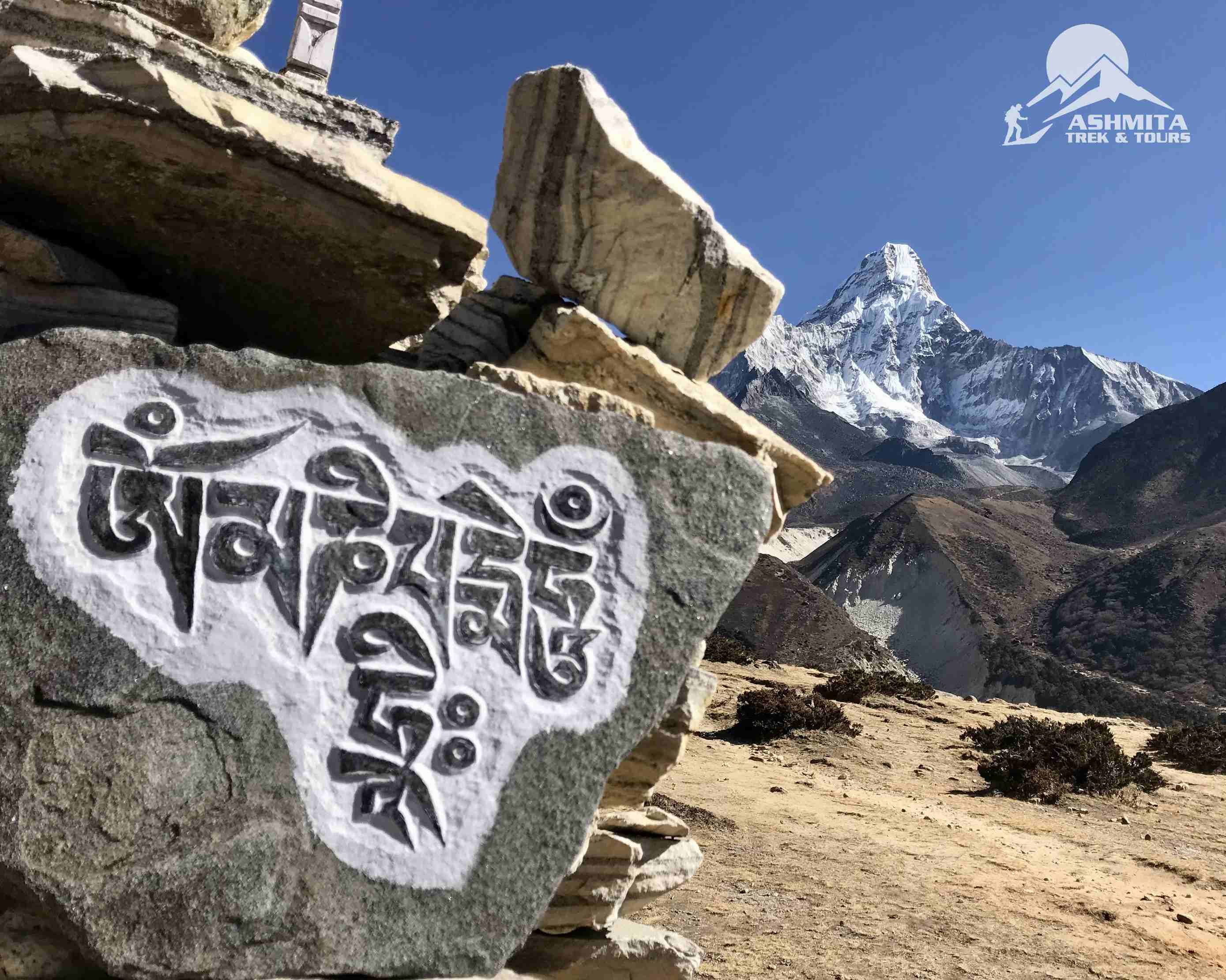 Buddhist chant carved on stone with the background of Amadablam