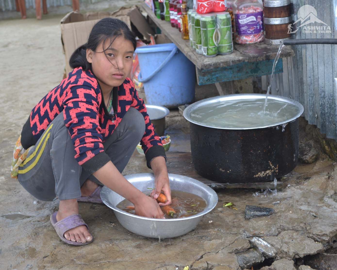 Local resident of the village washing the organic carrot