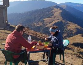 Ashmita Trek and Tours guest pic during breakfast time with background ridge